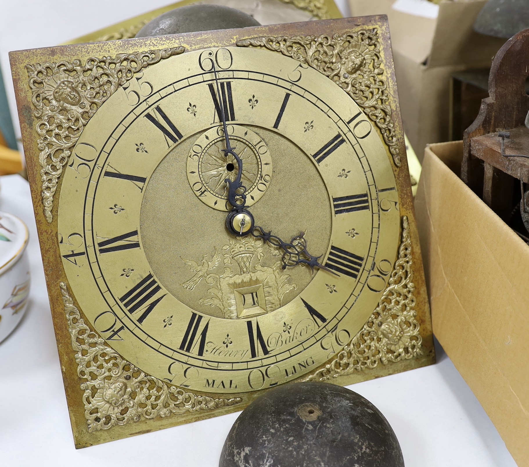 A large quantity of clock parts, to include movements, dials etc., including a John Marshall of Chulmleigh clock face